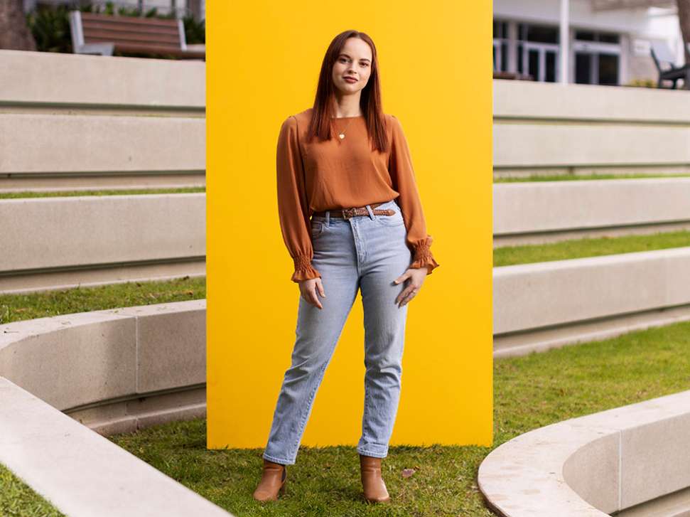 Psychological Science students standing in front of yellow rectangle