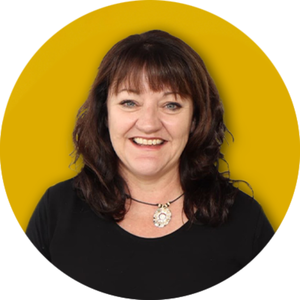 Smiling woman in a black top standing in front of a Flinders University branded backdrop.