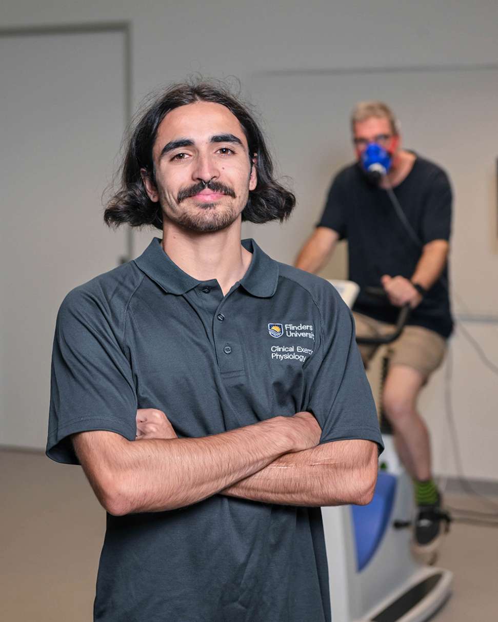 Flinders Clinical Exercise Physiologist Student with man riding bike in the background