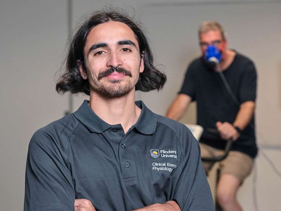 Flinders Clinical Exercise Physiologist Student with man riding bike in the background