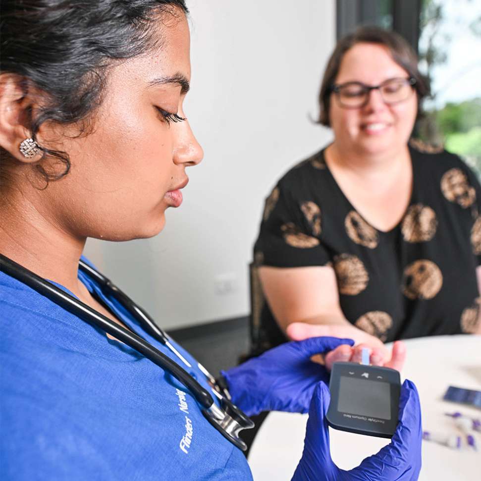 Flinders nursing student testing blood sugar level