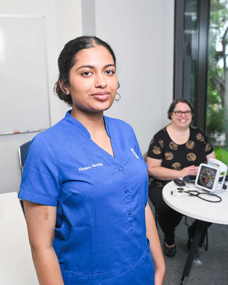 Flinders Nursing student with diabetes patient sitting and smiling in background