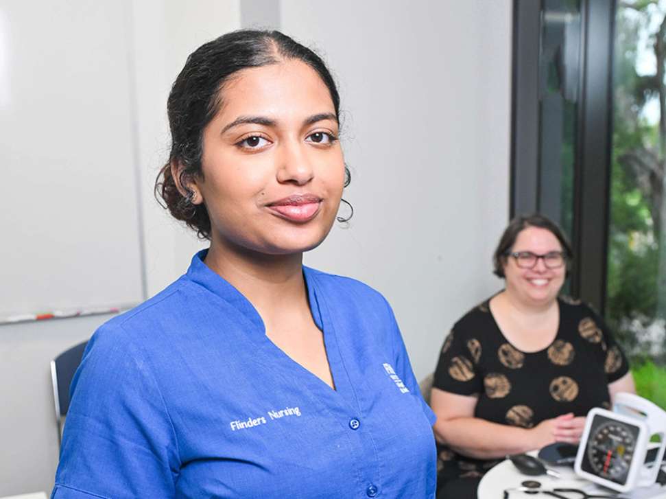 Flinders Nursing student with diabetes patient sitting and smiling in background