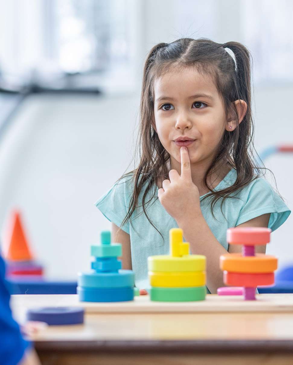 Young girl practicing speech pathology exercises