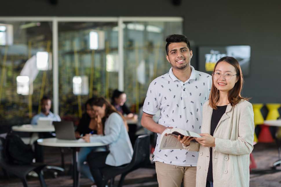 Flinders students talking in the library