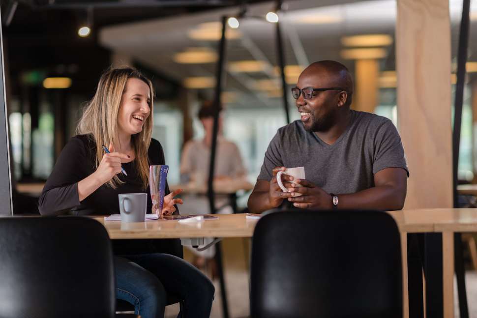 Flinders students talking in the library