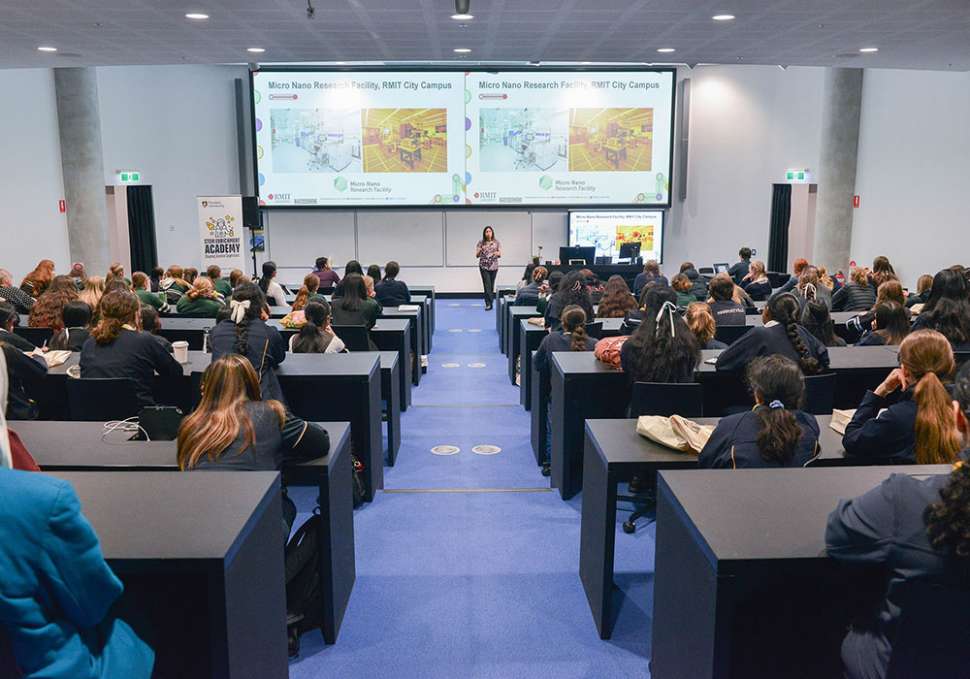 Lecture theatre full of girls listening to a role model talk about STEM careers