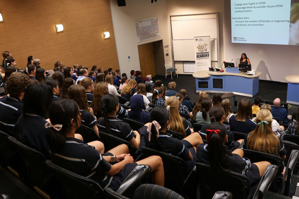Lecture theatre full of girls listening to a role model talk about STEM careers